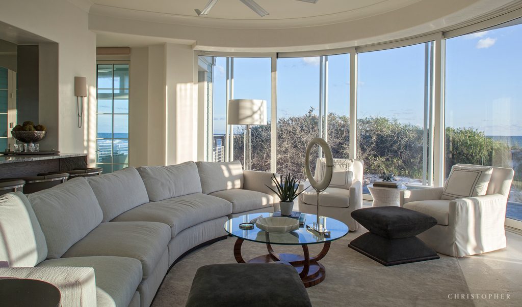 Coastal Luxury Living Room and Glass Motorized Wall System with Beach View