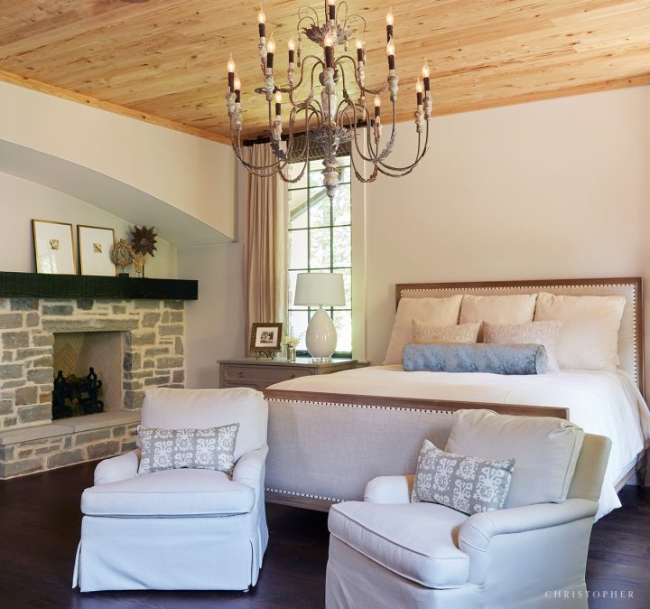 French Normandy Master Bedroom with Stone Fireplace and Pecky Cypress Ceilings